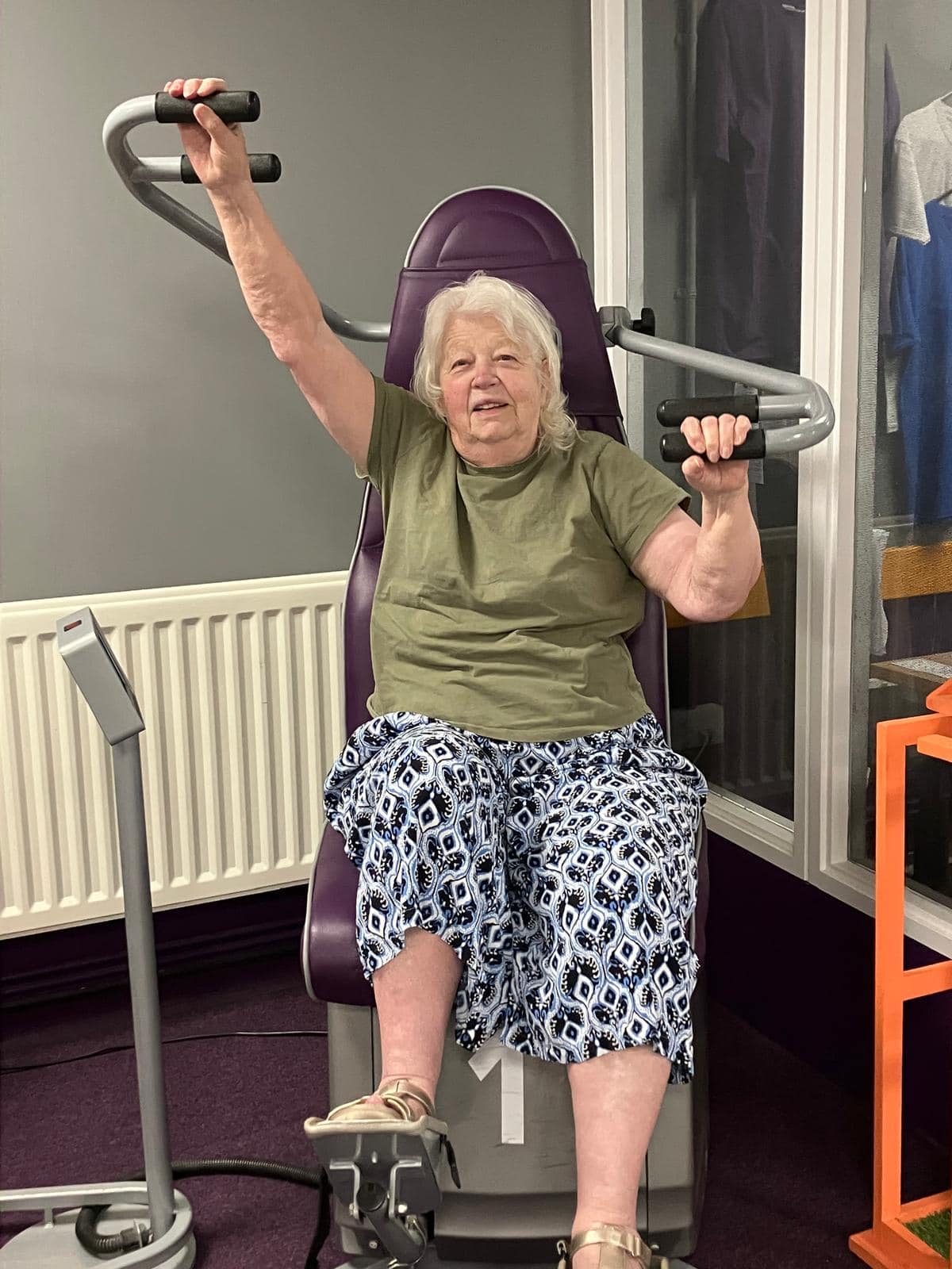 Older woman exercising with strength training equipment at Rehab & Fitness Center